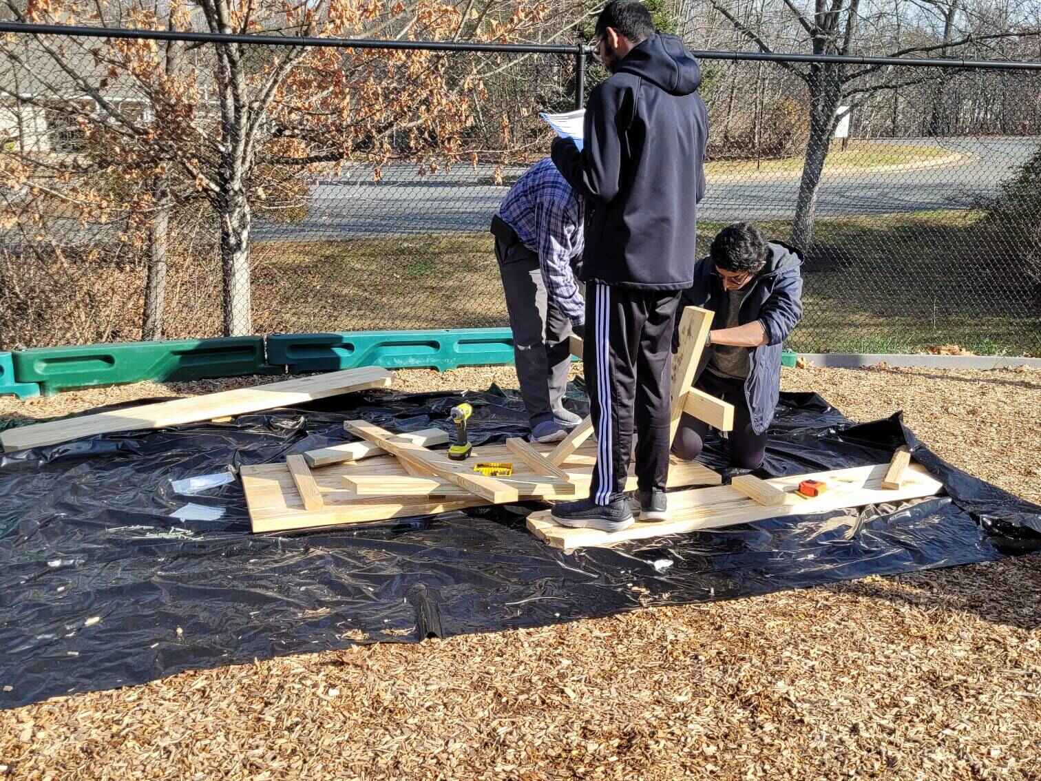 Scouts attatching legs to the second table